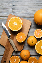 Freshly cut oranges on a rustic wooden background