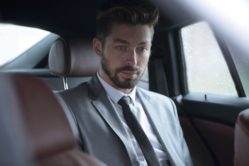 Fototapeta na wymiar Handsome business man in car.