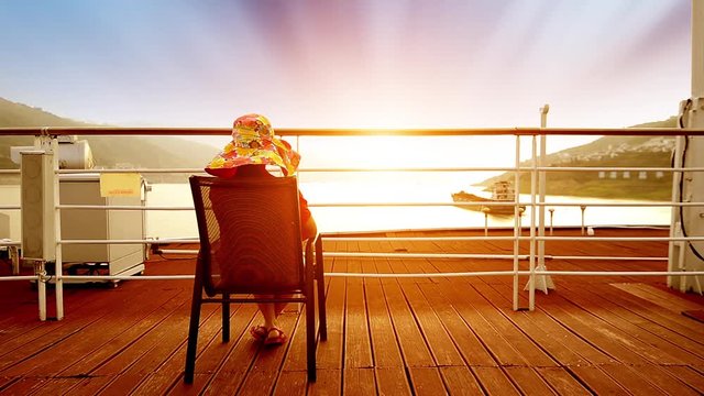 Woman sitting on deck of cruise ship
