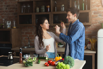 Happy couple cooking healthy food together