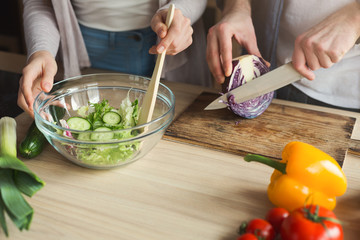 Closeup of couple cooking healthy food together