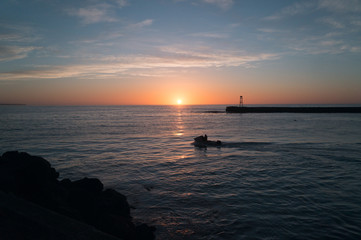 Fototapeta na wymiar Small boat and sunrise