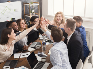 Successful business team is giving high five