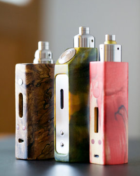 high end stabilized wood regulated box mods with rebuildable dripping atomizer and drip tip, vaping device, vape gear, vaporizer equipment, selective focus