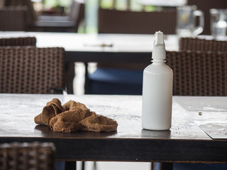 Brown table wipes and white water cylinder put on the table after the customer finished eating....