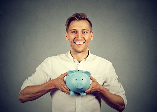 Happy man with blue piggy bank