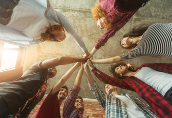 Group of friends holding hands together