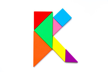Color tangram puzzle in english alphabet k shape on white background