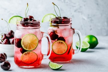 Cherry Limeade or Lemonade in glass mason jar. Ice cold summer drink.