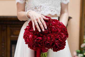 Wedding bouquet of flowers in the hands of the bride