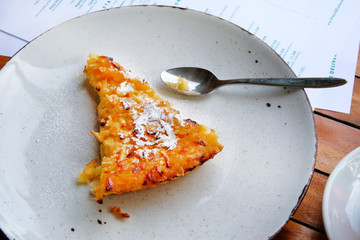 Slice of freshly baked apple open pie on porcelain plate, closeup