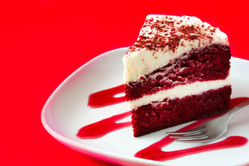 Red Velvet cake slice on red background. 