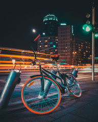 Bicycle Parked On Street Against Illuminated Light Trails At Night