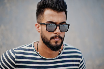 Handsome tall arabian beard man model at stripped shirt posed outdoor. Fashionable arab guy at...