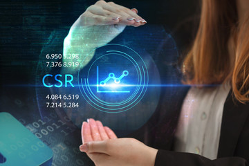 The concept of business, technology, the Internet and the network. A young entrepreneur working on a virtual screen of the future and sees the inscription: CSR