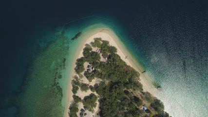 Tropical island with white sandy beach. Aerial view: Putipot island with colorful reef. Seascape, ocean and beautiful beach paradise. Philippines,Luzon. Travel concept.