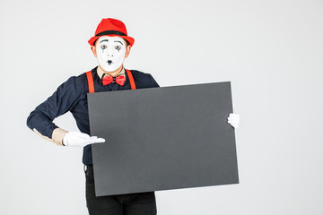 happy MIME artist holding a blank white Board, on a white background