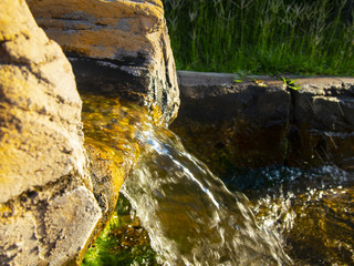 pure clear water flows from a natural source