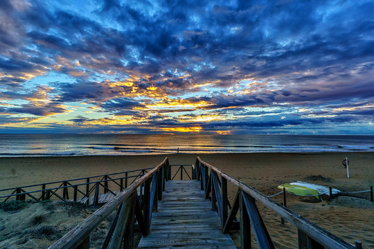 Sunrise over the Mediterranean sea with a wooden board walk