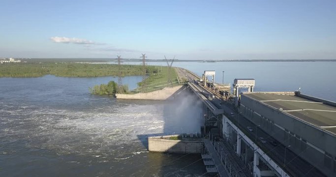 Aerial view to the Novosibirsk hydroelectric power station with waterfall on a sunny summer windless day with rainbow