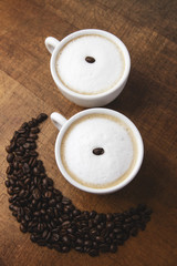 Morning coffee smile cups on wooden background