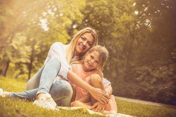 Fototapeta premium Portrait of Mother and daughter at nature.