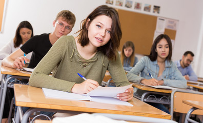 Obraz premium Girl is writing test and answer about task