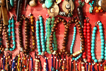 A lot of colorful bracelets and beads on a street market.