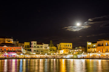 Fototapeta na wymiar Full moon over the old port of Chania