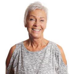 happy senior woman in her sixties with toothy smile