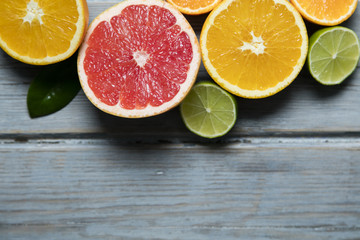 Citrus fuits, grapefruit, lemon, lime, orange on a rustic wooden background