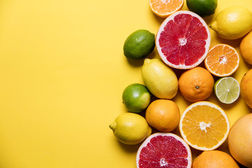 Citrus fuits, grapefruit, lemon, lime, orange on a yellow background