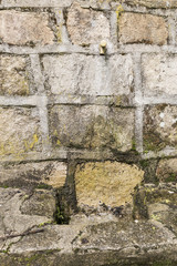 Stone fountain with an iron spout with water running
