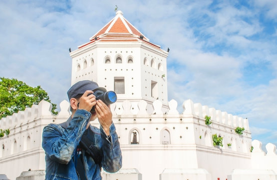 man traveler with bag cross body and hat and take a photo at &ldquo;Phra Sumen Fort&rdquo; background from Bangkok Thailand. Traveling Thailand.
