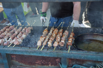 Unidentified men prepare barbecue on the grill in Kutaisi, Georgia
