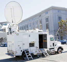 Satellite news van parked near urban government building