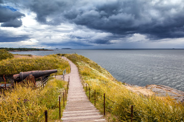 Wooden paths stairs along the coast on the island of Suomenlinna, a beautiful seascape. Islands of...