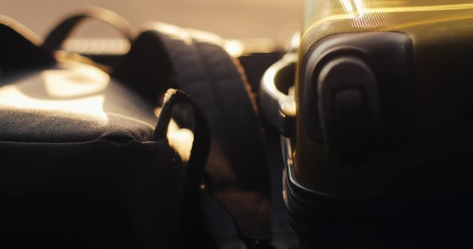 Close-up, Man putting suitcases in open car trunk for journey. sunlight. Vacation concept, moving, family car trip