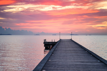 Sunset at lake, Long wooden pier with the orange sky during sunset