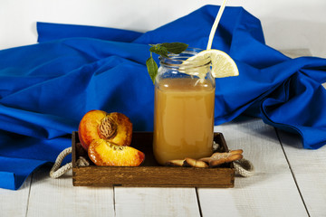 Peach fresh juice with fresh peaches on a white background. Top view, copy space. Fresh juice with peach. Healthy food fresh peaches.
