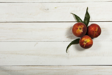 Peach fresh juice with fresh peaches on a white background. Top view, copy space. Fresh juice with peach. Healthy food fresh peaches.