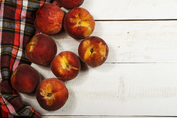Peach fresh juice with fresh peaches on a white background. Top view, copy space. Fresh juice with peach. Healthy food fresh peaches.