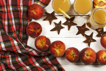 Peach fresh juice with fresh peaches on a white background. Top view, copy space. Fresh juice with peach. Healthy food fresh peaches.