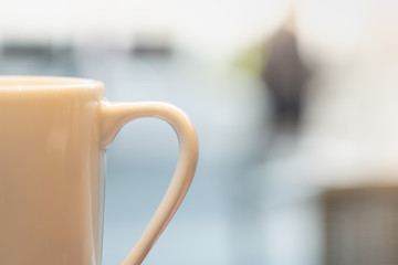 Close up of white mug cup of hot coffee.