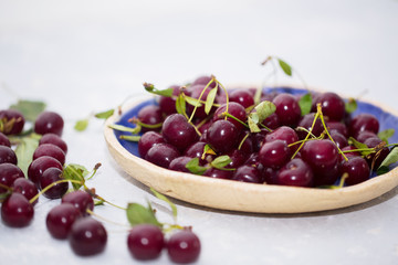 Fresh cherry in a plate on the table. Wild berries, healthy vitamins and summer