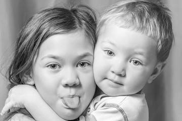 Two beautiful sisters hugging posing on camera