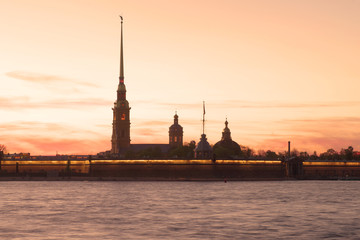 Silhouette of the Peter and Paul Cathedral on the background of the red May sunset. Saint-Petersburg, Russia