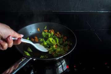 Fry the broccoli and carrots. Vegetarian dish. Process of cooking.