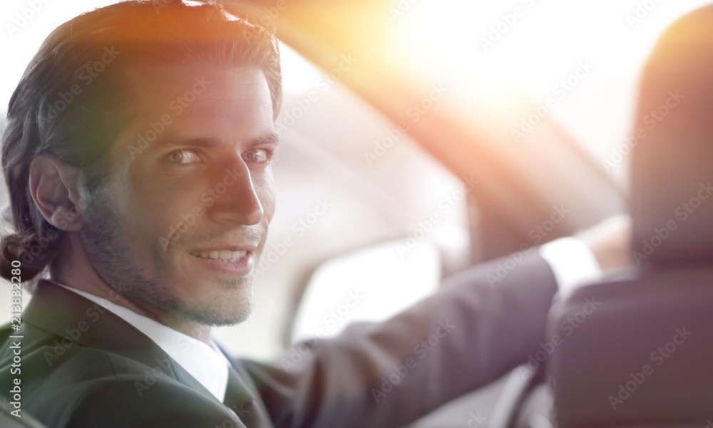 Wall mural man sitting behind the wheel of a car