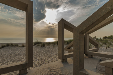 wooden structure on beach during sunset